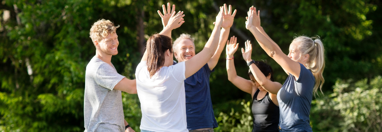 people smiling and high fiving each other