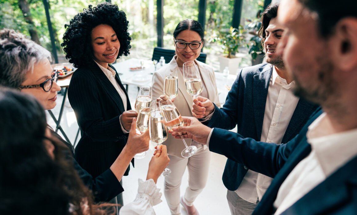 Businessmen and businesswomen making a corporate party after the business conference to celebrate the year goals and achievements.