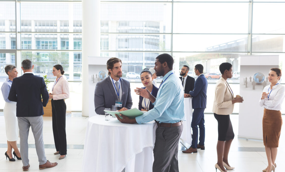 Business people discussing over documents at table during a semi