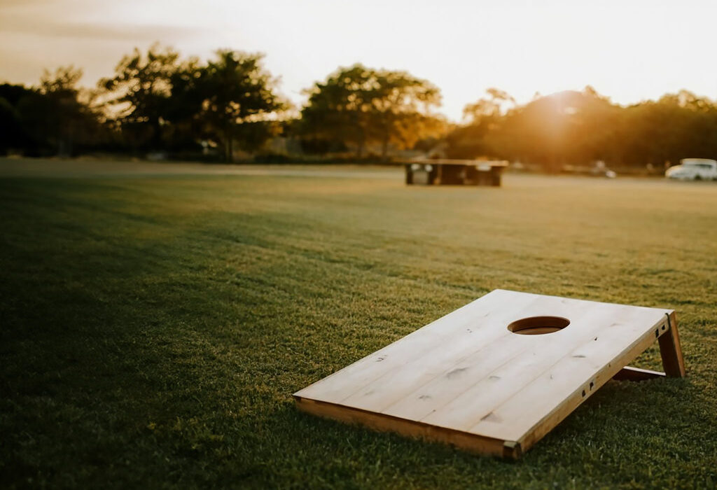 cornhole game in a field
