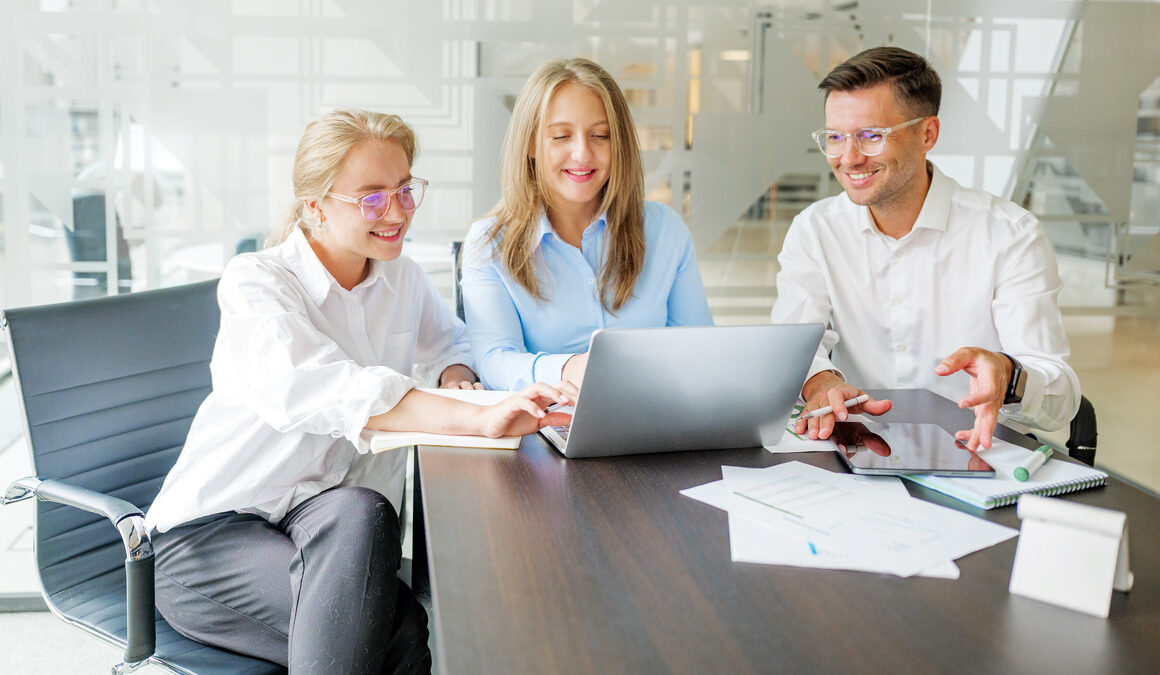 Downloaded Team members working together on project in office